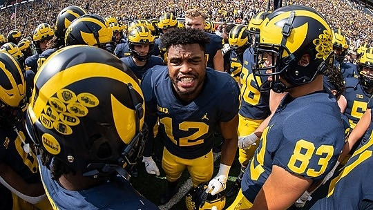 Josh Ross (12), Erick All (83), and Michigan Team