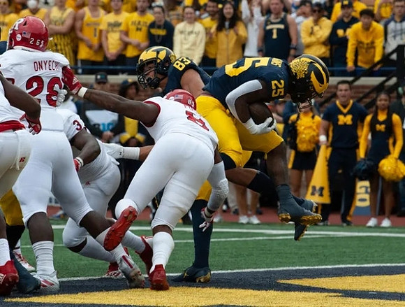 Erick All (83), and Hassan Haskins (25)