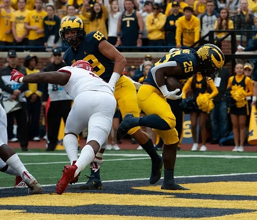 Erick All (83), and Hassan Haskins (25)