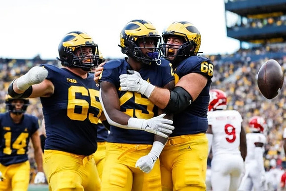 Roman Wilson (14), Zak Zinter (65), Hassan Haskins (25), and Andrew Vastardis (68)