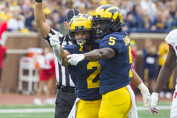 Blake Corum (2), and Mike Sainristil (5)