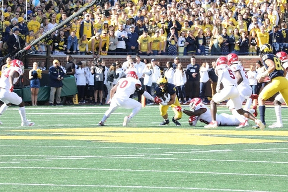 Blake Corum (2), and Erick All (83)