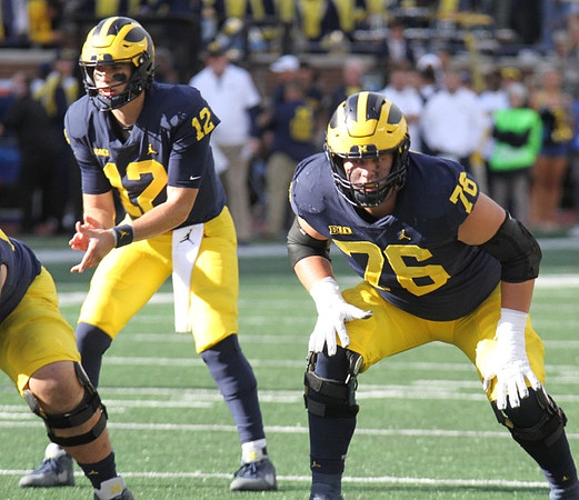 Cade McNamara (12), and Ryan Hayes (76)