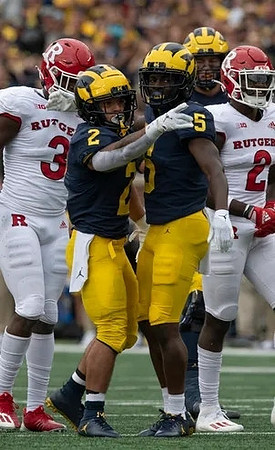 Blake Corum (2), and Mike Sainristil (5)