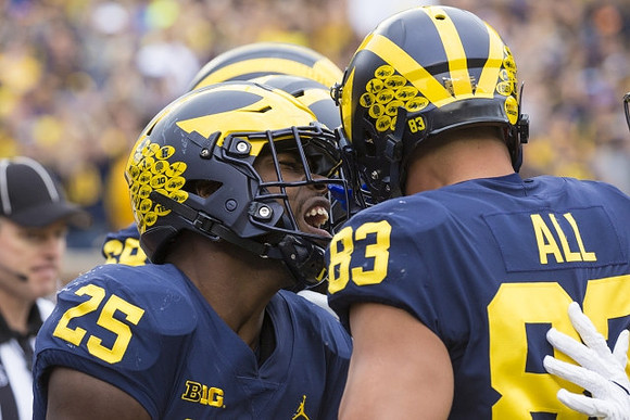 Hassan Haskins (25), and Erick All (83)