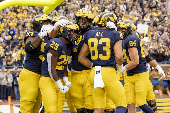 Trente Jones (53), Hassan Haskins (25), Trevor Keegan (77), Erick All (83), and Joel Honigford (84)