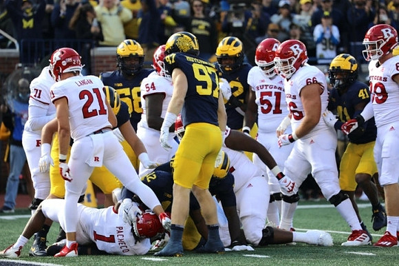 Mazi Smith (58), Aidan Hutchinson (97), and Nikhai Hill-Green (41)