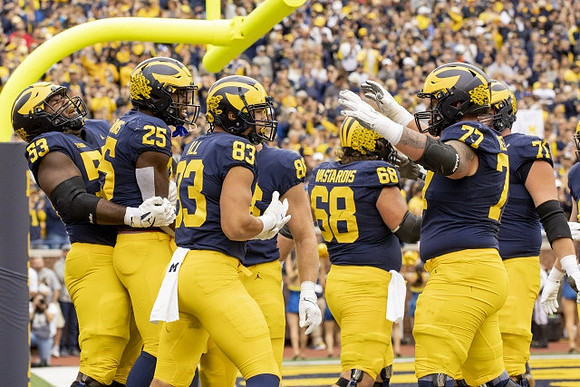 Trente Jones (53), Hassan Haskins (25), Erick All (83), Luke Schoonmaker (86), Andrew Vastardis (68), Trevor Keegan (77), and Andrew Stueber (71)