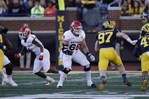 Aidan Hutchinson (97), and Nikhai Hill-Green (41)