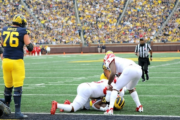 Ryan Hayes (76), and Hassan Haskins (25)
