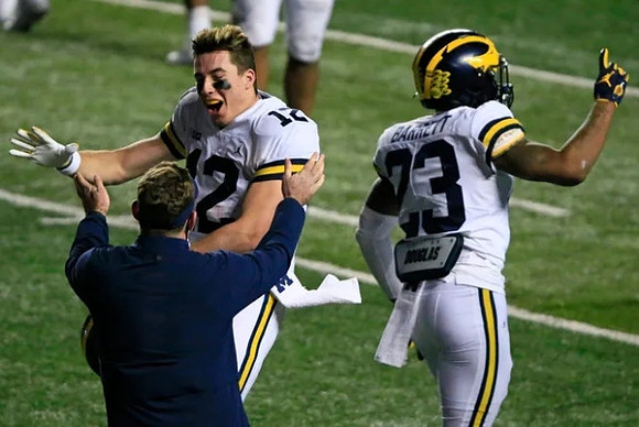 Cade McNamara (12) and Michael Barrett (23)