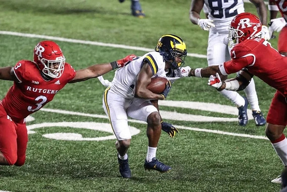 Mike Sainristil (19) and Nick Eubanks (82)