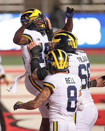 Mike Sainristil (19), Ronnie Bell (8), and Chuck Filiaga (66)