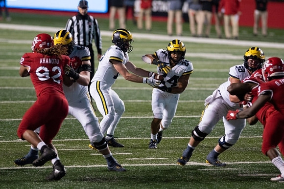 Chuck Filiaga (66), Cade McNamara (12), Zach Charbonnet (24), and Zach Carpenter (58)