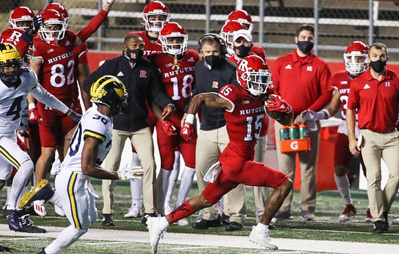 Vincent Gray (4), Daxton Hill (30), and Rutgers Head Coach Greg Schiano