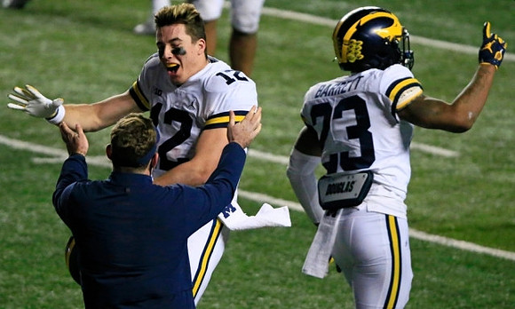 Cade McNamara (12) and Michael Barrett (23)