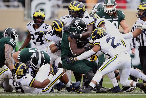 Khaleke Hudson (7), Lavert Hill (24), Brandon Watson (28), Kwity Paye (19), and Tyree Kinnel (23)