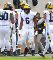 Bryan Mone (90), Josh Uche (6), and Chase Winovich (15)