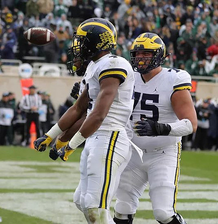 Nico Collins (4) and Jon Runyan Jr. (75)