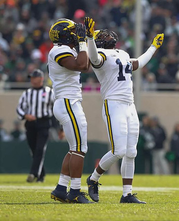 Khaleke Hudson (7) and Josh Metellus (14)