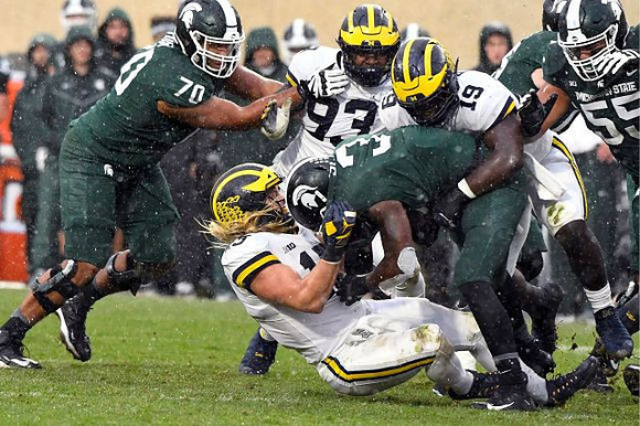 Chase Winovich (15), Lawrence Marshall (93), and Kwity Paye (19)