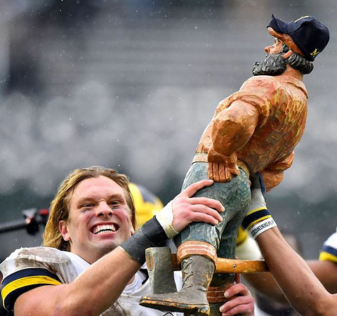Chase Winovich (15) and Paul Bunyan Trophy