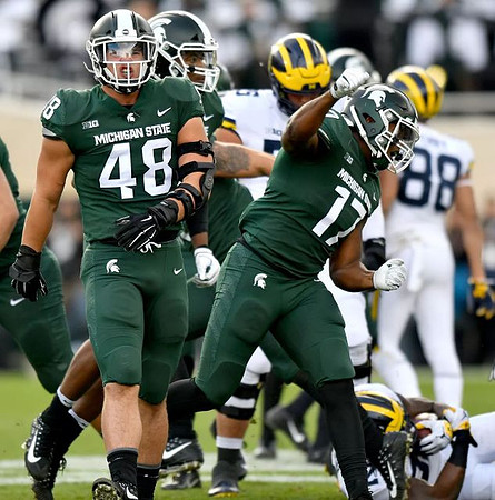Jon Runyan Jr. (75), Karan Higdon (22), and Grant Perry (88)