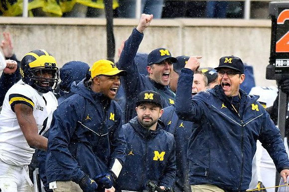Ambry Thomas (1) and Jim Harbaugh
