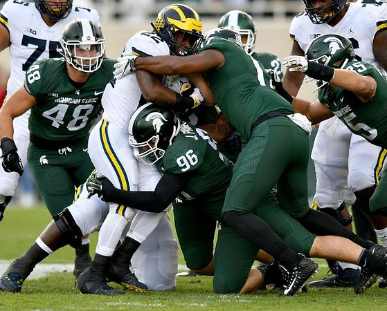 Jon Runyan Jr. (75), Karan Higdon (22), and Juwann Bushell-Beatty (76)