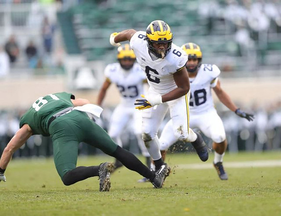 Tyree Kinnel (23), Josh Uche (6), and Brandon Watson (28)