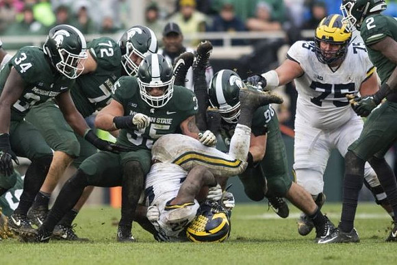 Karan Higdon (22) and Jon Runyan Jr. (75)