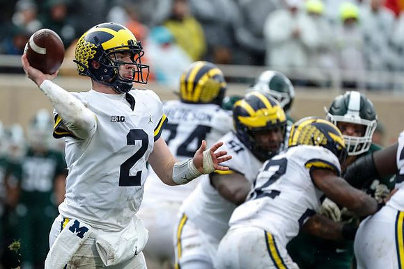 Shea Patterson (2), Ben Bredeson (74), Cesar Ruiz (51), and Karan Higdon (22)