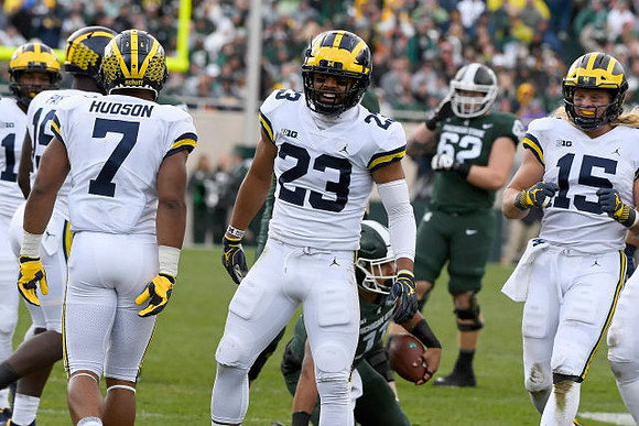 Kwity Paye (19), Khaleke Hudson (7), Tyree Kinnel (23), and Chase Winovich (15)