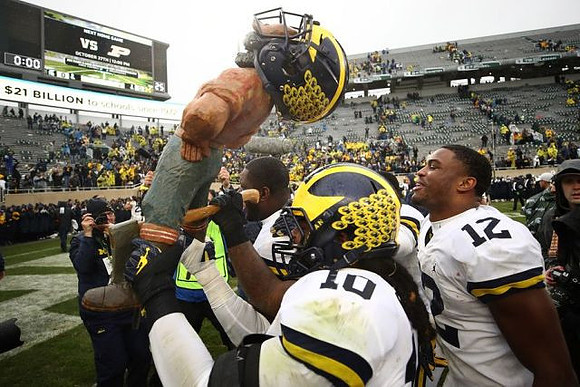 Paul Bunyan Trophy , Devin Bush (10), and Josh Ross (12)