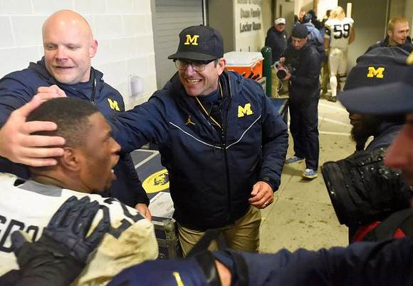 Karan Higdon (22) and Jim Harbaugh
