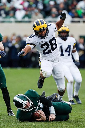 Brandon Watson (28) and Josh Metellus (14)