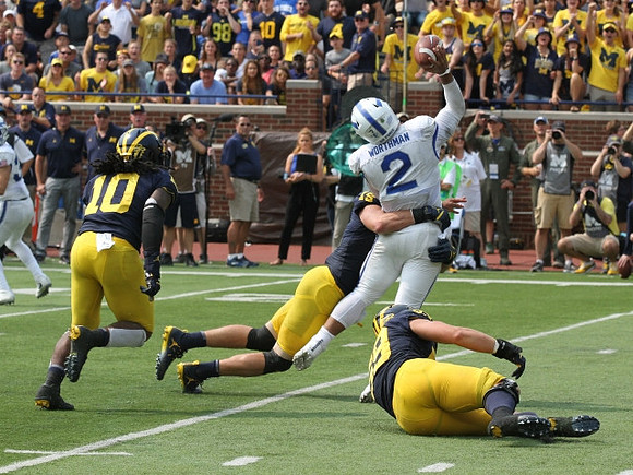 Devin Bush (10), Chase Winovich (15), and Noah Furbush (59)
