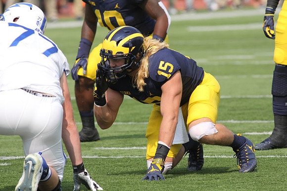 Devin Bush (10) and Chase Winovich (15)