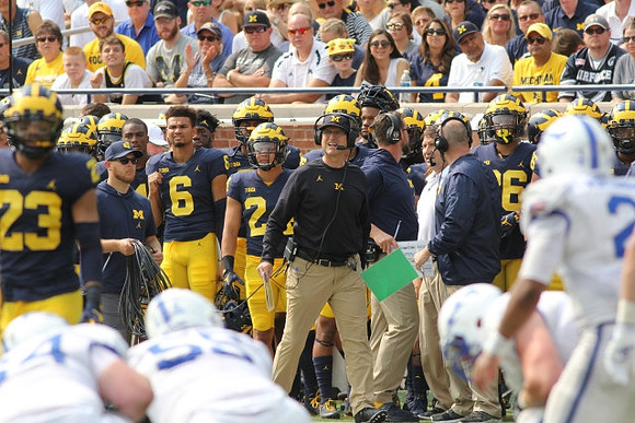 Tyree Kinnel (23) and Jim Harbaugh