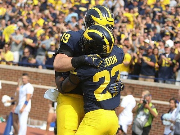 Henry Poggi (19) and Karan Higdon (22)