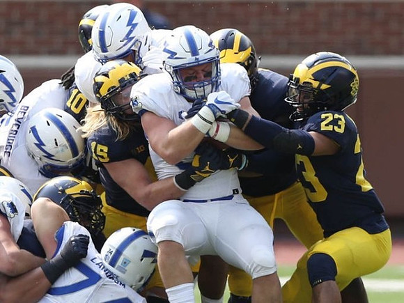 Devin Bush (10), Chase Winovich (15), and Tyree Kinnel (23)