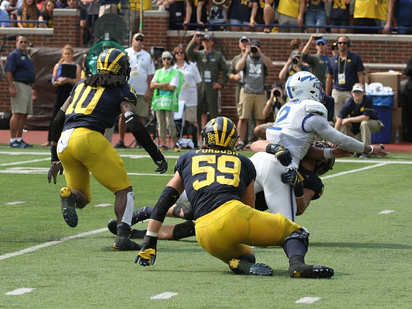 Devin Bush (10), Chase Winovich (15), and Noah Furbush (59)