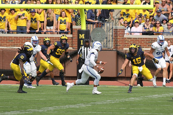 Devin Bush (10), Noah Furbush (59), and Chase Winovich (15)