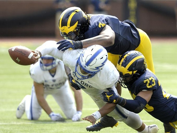 Rashan Gary (3) and Tyree Kinnel (23)