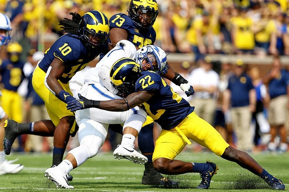 Devin Bush (10), David Long (22), and Maurice Hurst (73)