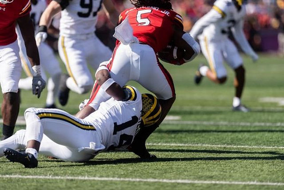 Josh Metellus (14) and Aidan Hutchinson (97)