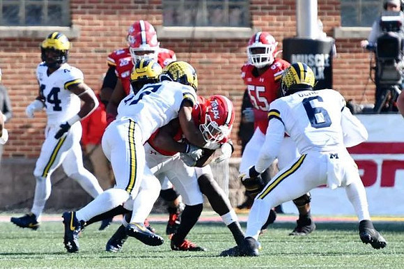 Cameron McGrone (44), Khaleke Hudson (7), and Josh Uche (6)