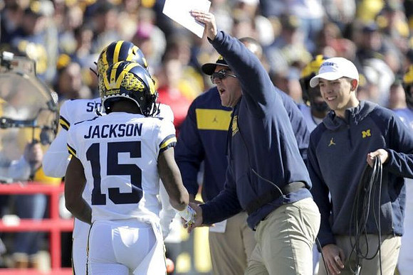 Giles Jackson (15) and Jim Harbaugh