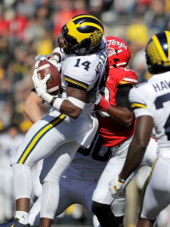 Josh Metellus (14), Daxton Hill (30), and Brad Hawkins (20)
