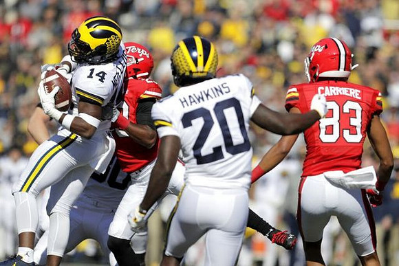 Daxton Hill (30), Josh Metellus (14), and Brad Hawkins (20)